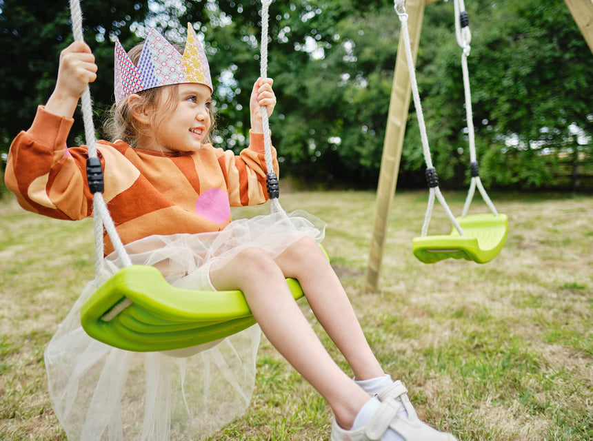 Child on swing with crown